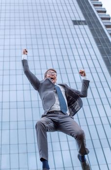 jubilant business men showing his success outdoors . photo with copy space