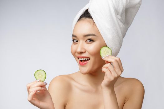 Beauty young asian women skin care image with cucumber on white background studio