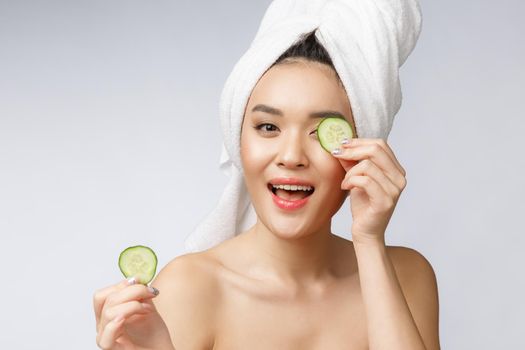 Beauty young asian women skin care image with cucumber on white background studio