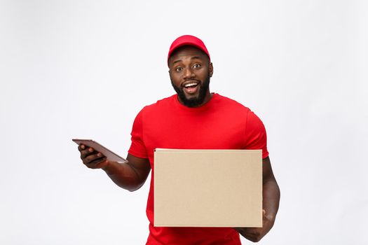 Delivery Concept - Portrait of Handsome African American delivery man or courier showing a confirmation document form to sign. Isolated on Grey studio Background. Copy Space.