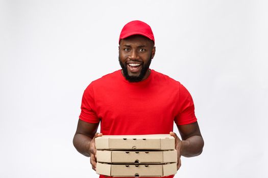 Delivery Concept - Portrait of Handsome African American Pizza delivery man. Isolated on Grey studio Background. Copy Space.
