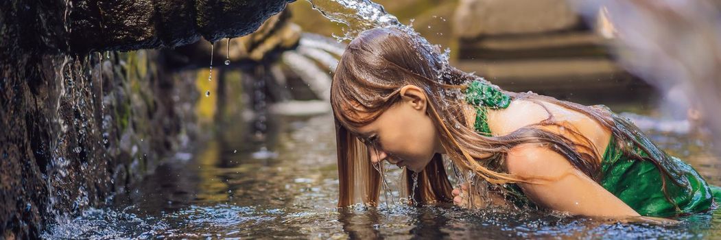 Woman in holy spring water temple in bali. The temple compound consists of a petirtaan or bathing structure, famous for its holy spring water. BANNER, LONG FORMAT