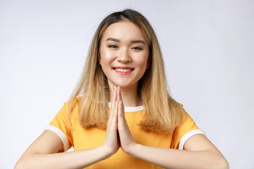 Portrait charming beautiful woman. Attractive beautiful woman give pay to customer or welcome, respect, hello to someone. It is a Thai culture. She look friendly with isolated on white, copy space.