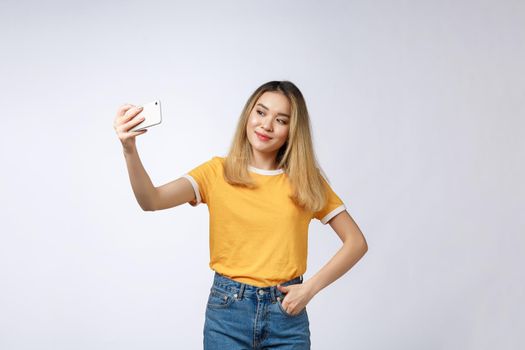 Close-up of young Asian beautiful woman taking selfie. Isolated white background.Beauty and Healthy Woman