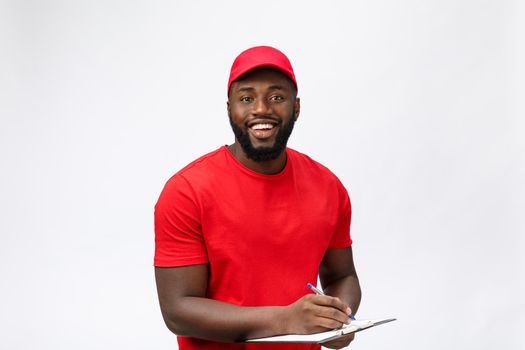 Delivery Concept - Portrait of Handsome African American delivery man or courier showing a confirmation document form to sign. Isolated on Grey studio Background. Copy Space.