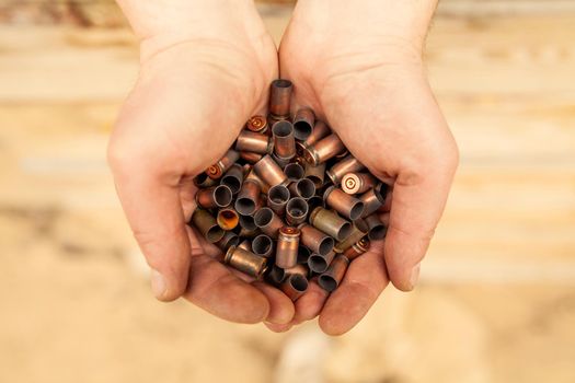 cases from the military cartridges in the hands of the men of war concept