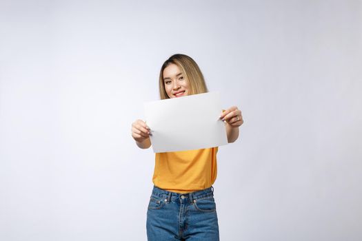 Excited woman showing empty blank paper card sign with copy space for text. Gorgeous multi ethnic Chinese Asian and white Caucasian female model isolated on white background.