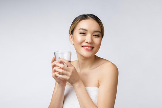 relaxed young smiling woman drinking clean water