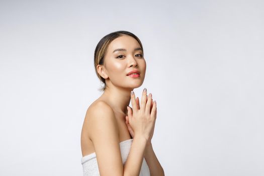 Sided portrait of Asian beautiful smiling girl with short hair showing her healthy skin on the isolated white background.