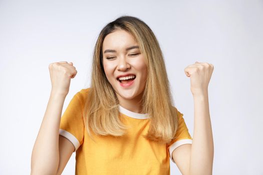 Young Asian woman with surprised excited happy screaming. Cheerful girl with funny joyful face expression.