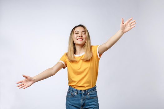 Closeup portrait of pretty young woman motioning with arms to come and give her a bear hug, isolated on white background. Positive emotion facial expression feeling, signs symbols, body language