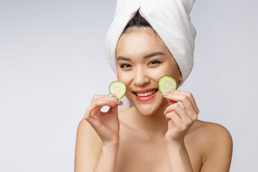 Beauty young asian women skin care image with cucumber on white background studio