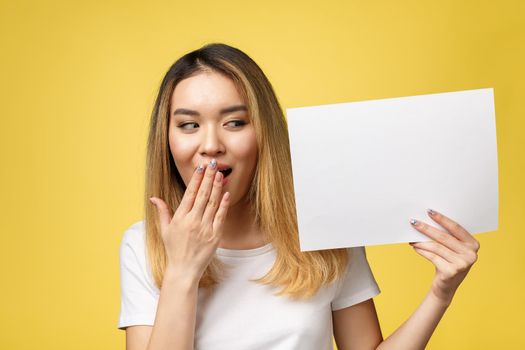 Attractive young beautiful Asian student woman holding blank white paper