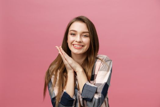 Portrait of beautiful brunette caucasian woman in pink studio.