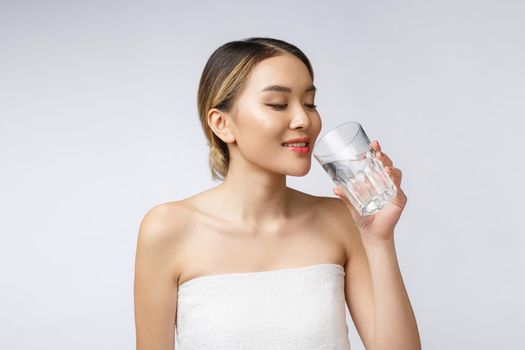 relaxed young smiling woman drinking clean water