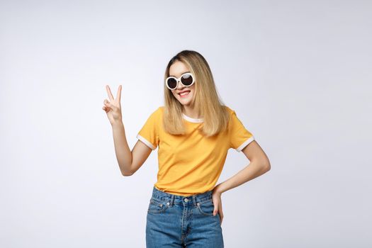 Young asian woman wearing sunglasses over isolated background showing and pointing up with fingers number two while smiling confident and happy