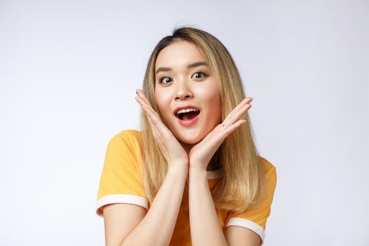 Young Asian woman with surprised excited happy screaming. Cheerful girl with funny joyful face expression.