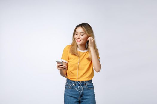 Portrait of happy Asian young woman listen to music with headphone