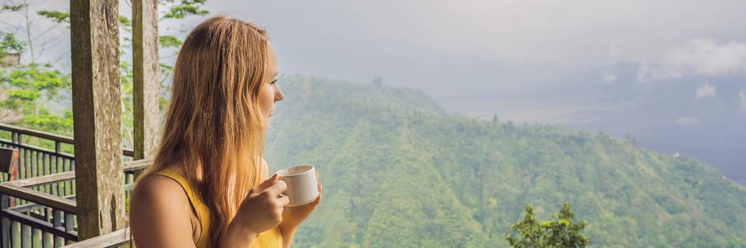 Young woman drinks coffee in a cafe in the mountains. BANNER, LONG FORMAT