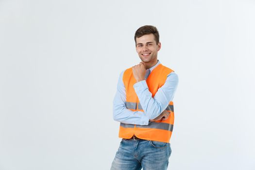 Visionary architect or engineer looking up and thinking about new projects. Wearing reflective vest isolated on white background