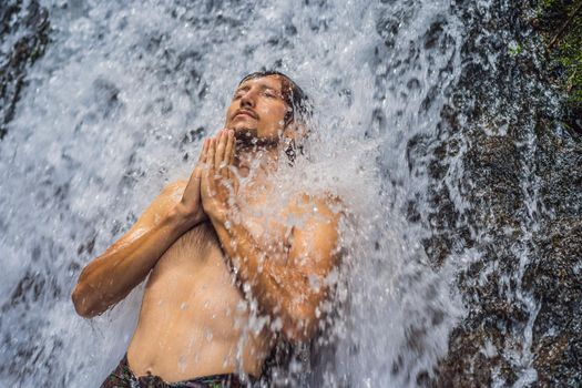 Young man tourist in Holy springs Sebatu in Bali.