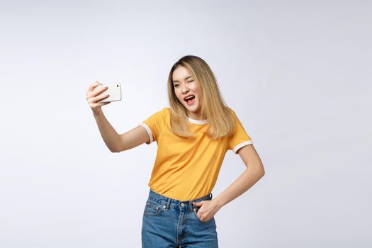 Close-up of young Asian beautiful woman taking selfie. Isolated white background.Beauty and Healthy Woman