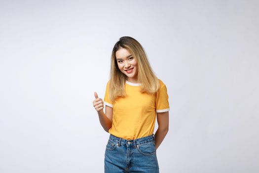 Young Asian woman show thumbs up on white background