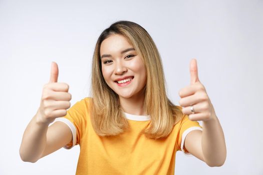 Young Asian woman show thumbs up on white background