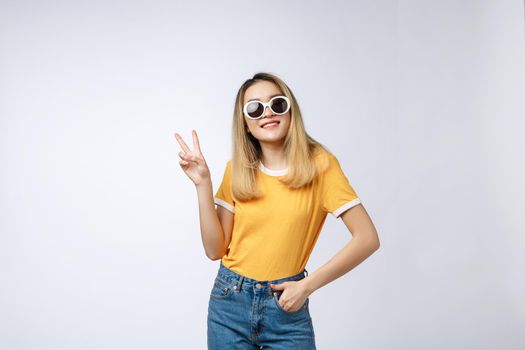 Young asian woman wearing sunglasses over isolated background showing and pointing up with fingers number two while smiling confident and happy