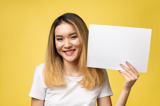 Attractive young beautiful Asian student woman holding blank white paper