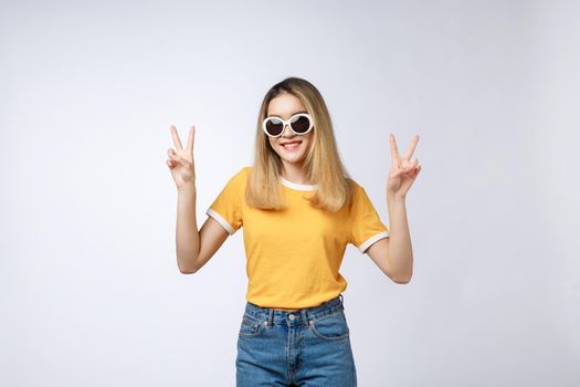 Young asian woman wearing sunglasses over isolated background showing and pointing up with fingers number two while smiling confident and happy