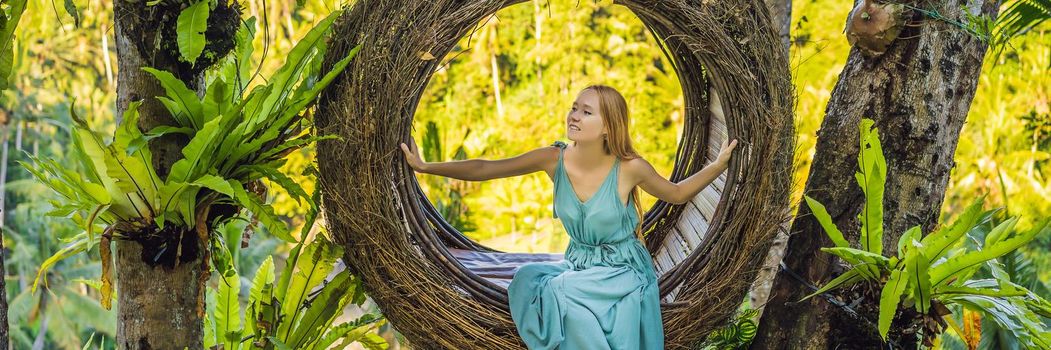 Bali trend, straw nests everywhere. Young tourist enjoying her travel around Bali island, Indonesia. Making a stop on a beautiful hill. Photo in a straw nest, natural environment. Lifestyle. BANNER, LONG FORMAT