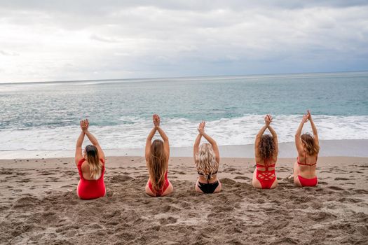 Big happy family or group of five friends is having fun against sunset beach. Beach holidays concept