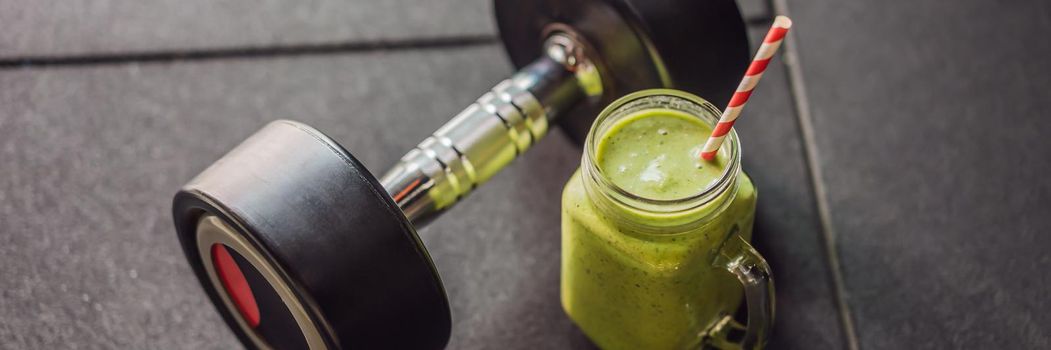 Green smoothies and dumbbells in the gym. BANNER, LONG FORMAT