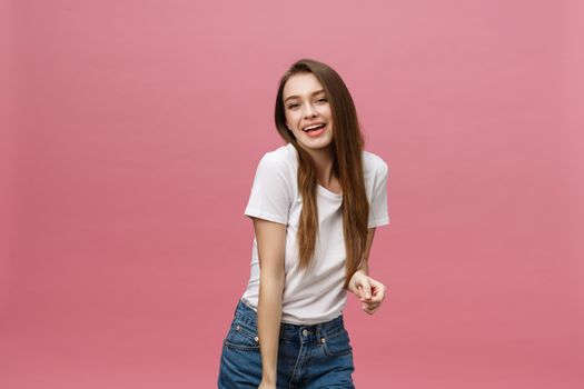 Surprised happy beautiful woman looking in excitement. Isolate over pink background and copy space