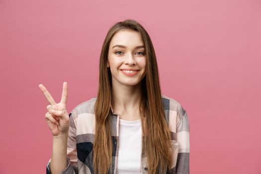 Young caucasian woman over isolated background smiling looking to the camera showing fingers doing victory sign. Number two.