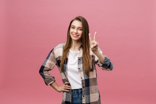 Young caucasian woman over isolated background smiling looking to the camera showing fingers doing victory sign. Number two.