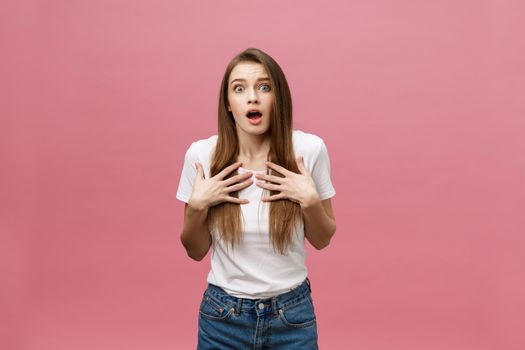 Surprised happy beautiful woman looking in excitement. Isolate over pink background and copy space