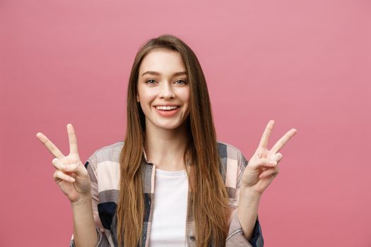 Young caucasian woman over isolated background smiling looking to the camera showing fingers doing victory sign. Number two.