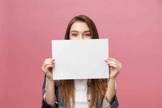 Young caucasian woman holding blank paper sheet over isolated background scared in shock with a surprise face,and excited with fear expression