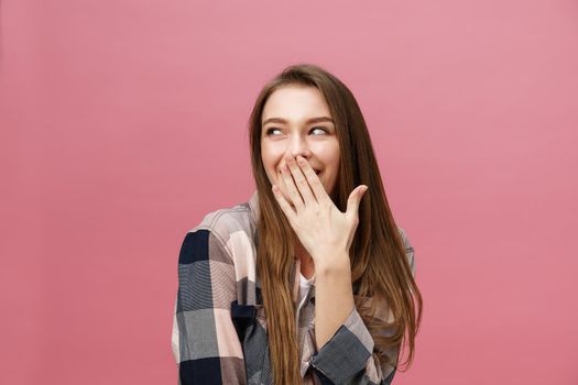 Surprised happy beautiful woman looking in excitement. Isolate over pink background and copy space