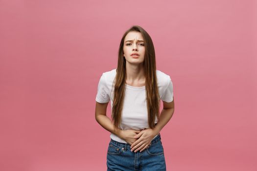 Young caucasian woman over isolated background with hand on stomach because indigestion, painful illness feeling unwell. Ache concept.