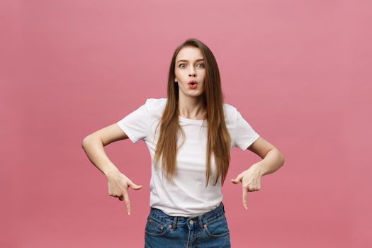 Woman pointing finger at camera and toothy smiling. Expression emotion and feelings concept. Studio shot, isolated on pink background.