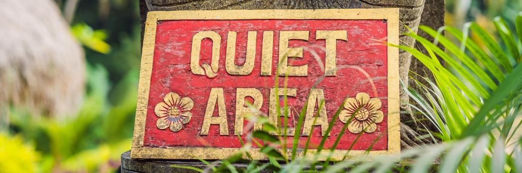 A sign QUIET AREA in a quiet corner of the garden. BANNER, LONG FORMAT