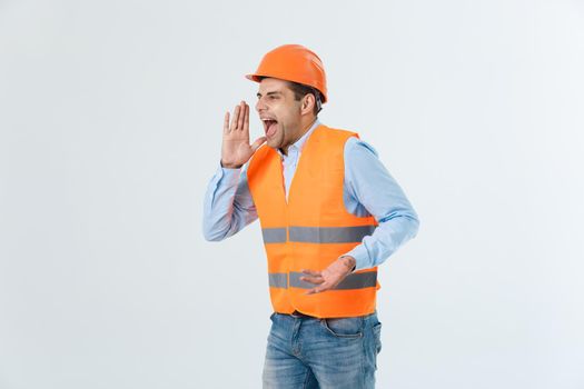 Angry engineer with angry face emotion shouting at someone raising his both hands, isolated on a white background