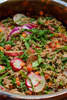 Beef salpicon close up photo. Mexican spicy beef steak salad with carrot, olives, chili, onion, lettuce and radish. Delicious Mexican cuisine