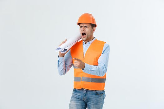 Disappointed handsome engineer wearing orange vest and jeans with helmet, isolated on white background.