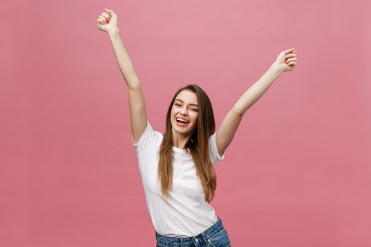 Happy successful young woman with smiling,shouting and celebrating success over pink background.