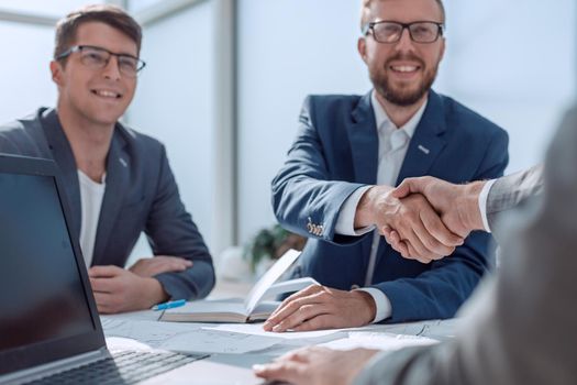 close up. business people shaking hands at a meeting in the office. concept of cooperation