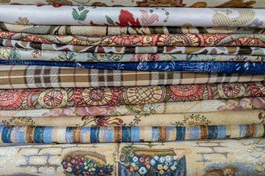 stack of colored fabric with different patterns, close-up full-frame background
